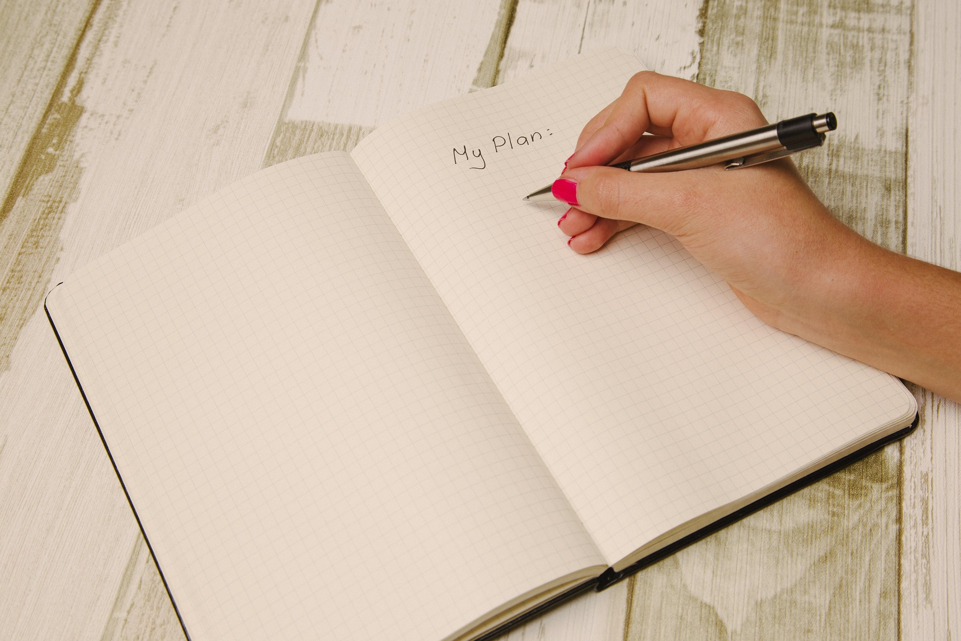 A realistic and organized to-do list placed on a desk with a pen.