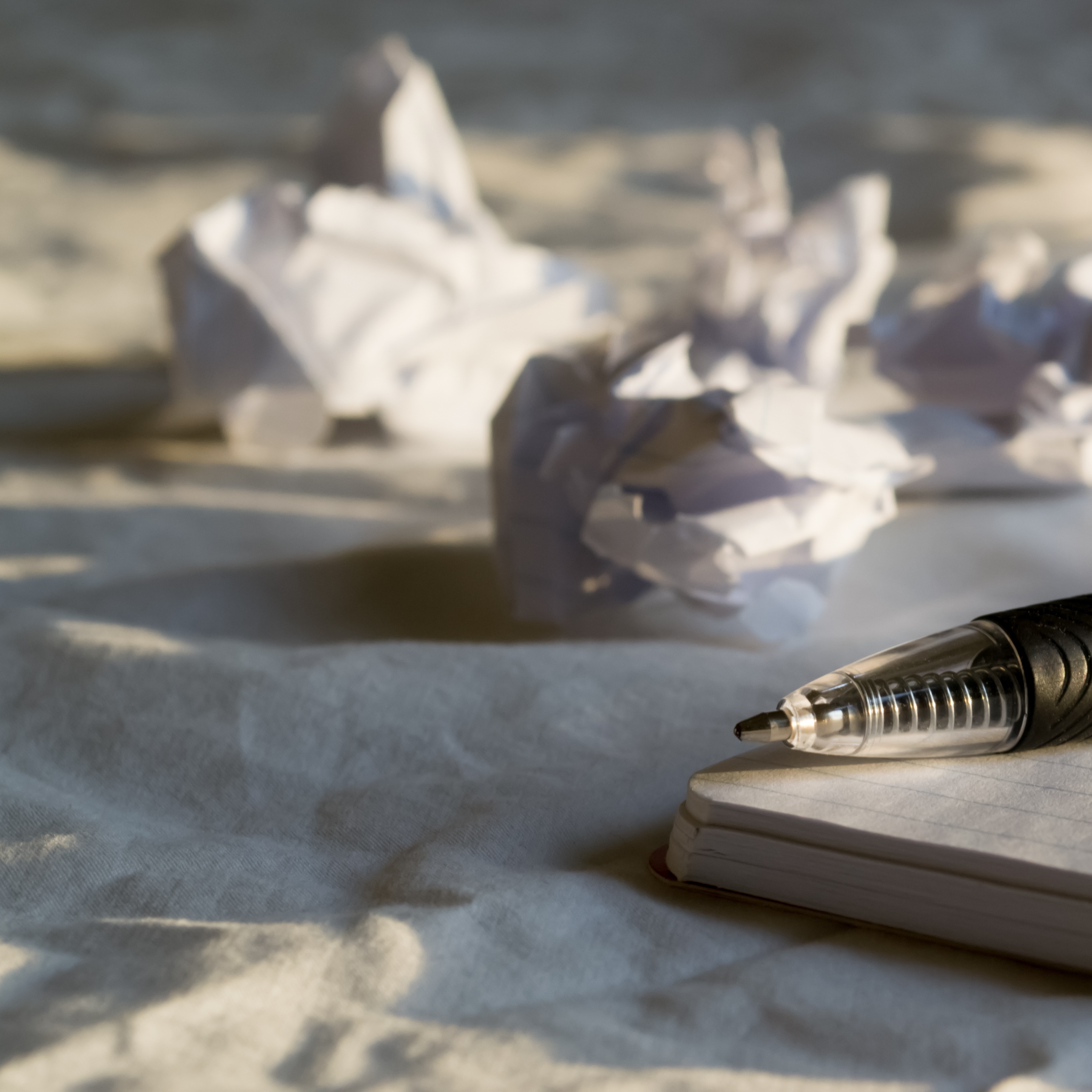 Crumpled paper and a fresh sheet representing lessons learned from failure.